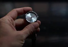 Una persona cambia la hora en su reloj de pulsera.