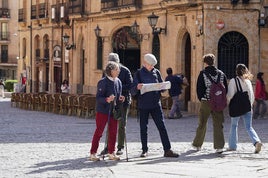 Dos turistas consultan un mapa del centro de la ciudad.