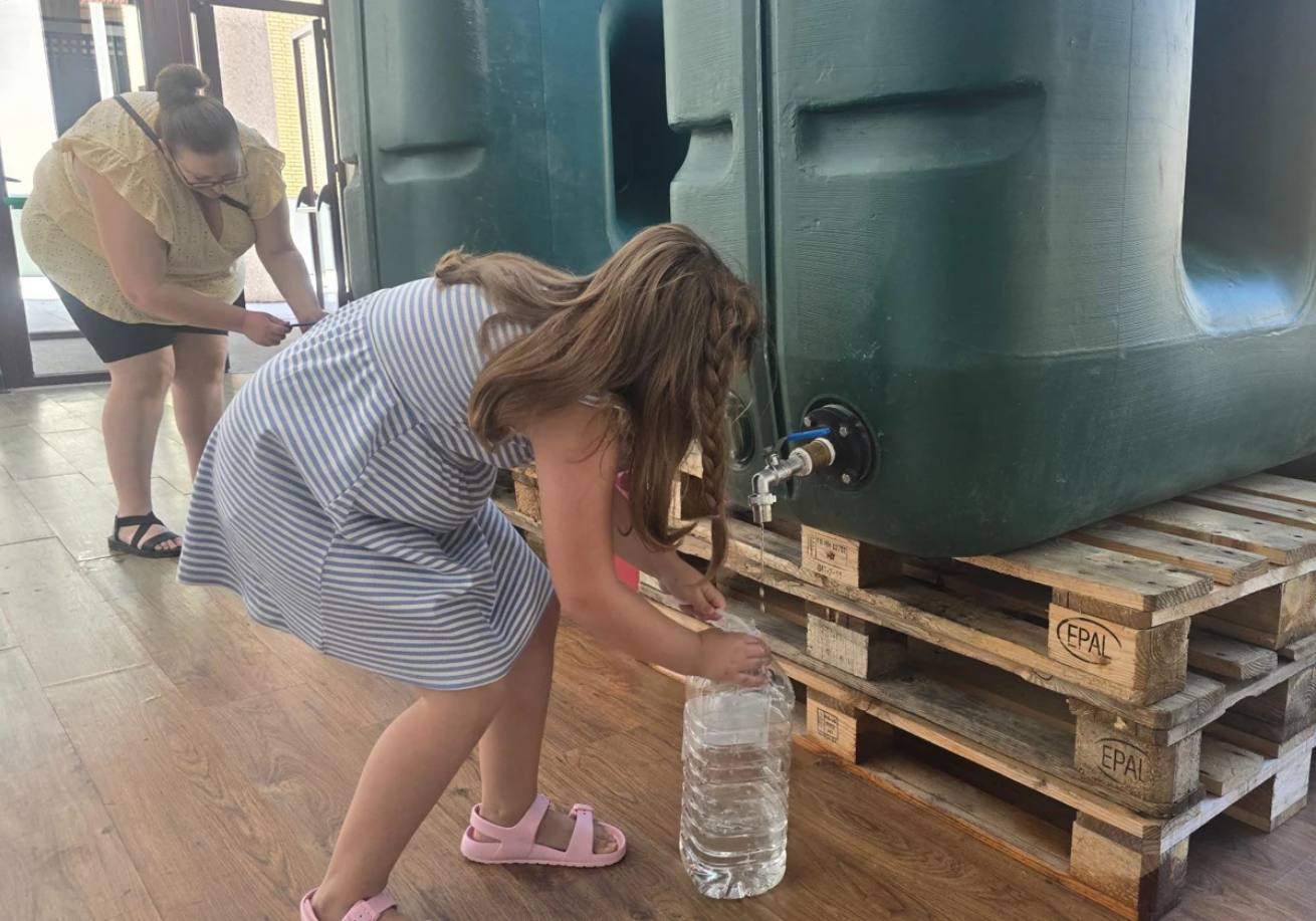 Vecinos de Ledesma cogiendo agua en el auditorio.