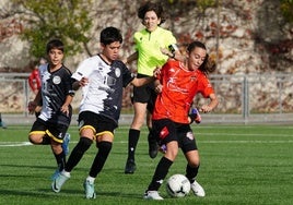 Una jugadora del Salamanca FF y un jugador de Unionistas pugnan por el control del balón durante un partido de la Segunda División alevín en el Vicente del Bosque.