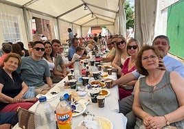 Familiares y amigos en torno al mantel durante la comida popular.
