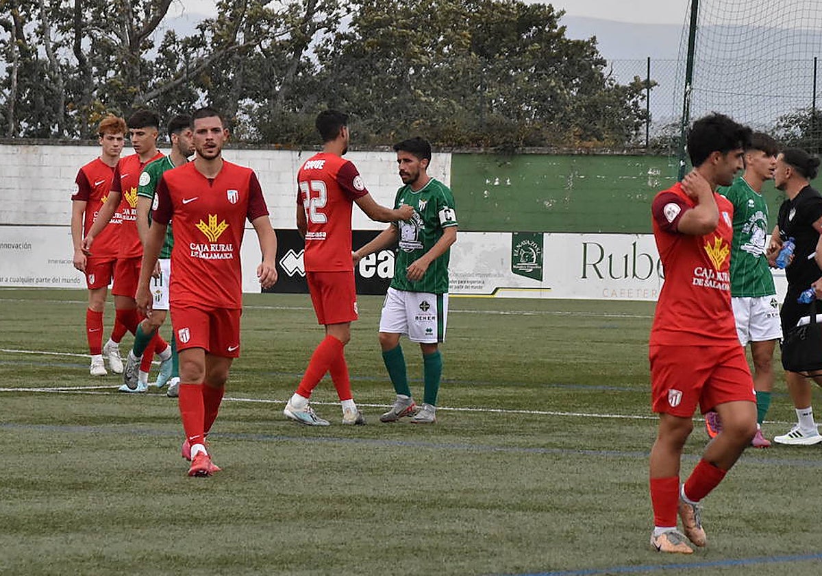 Los jugadores del Guijuelo y el Santa Marta, abandonando el campo al término del partido.