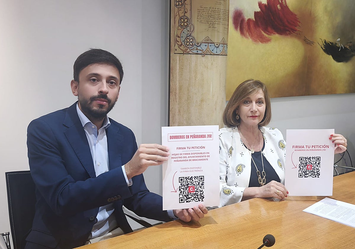 Fran Díaz y Carmen Ávila muestran el código QR para la recogida de firmas.