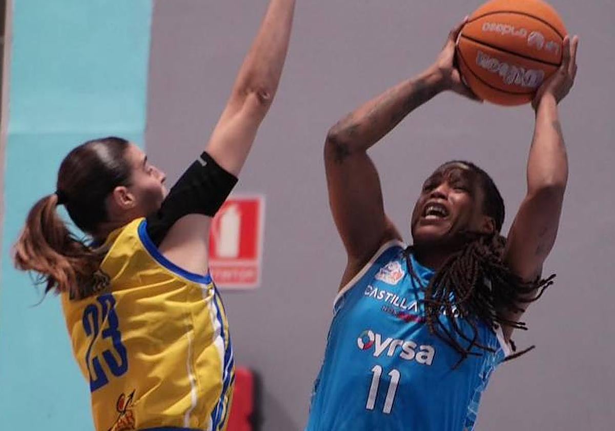 Shavonte Zellous intenta anotar en una acrobática postura defendida por Claudia Contell, la jugadora más destacada del Gran Canaria.