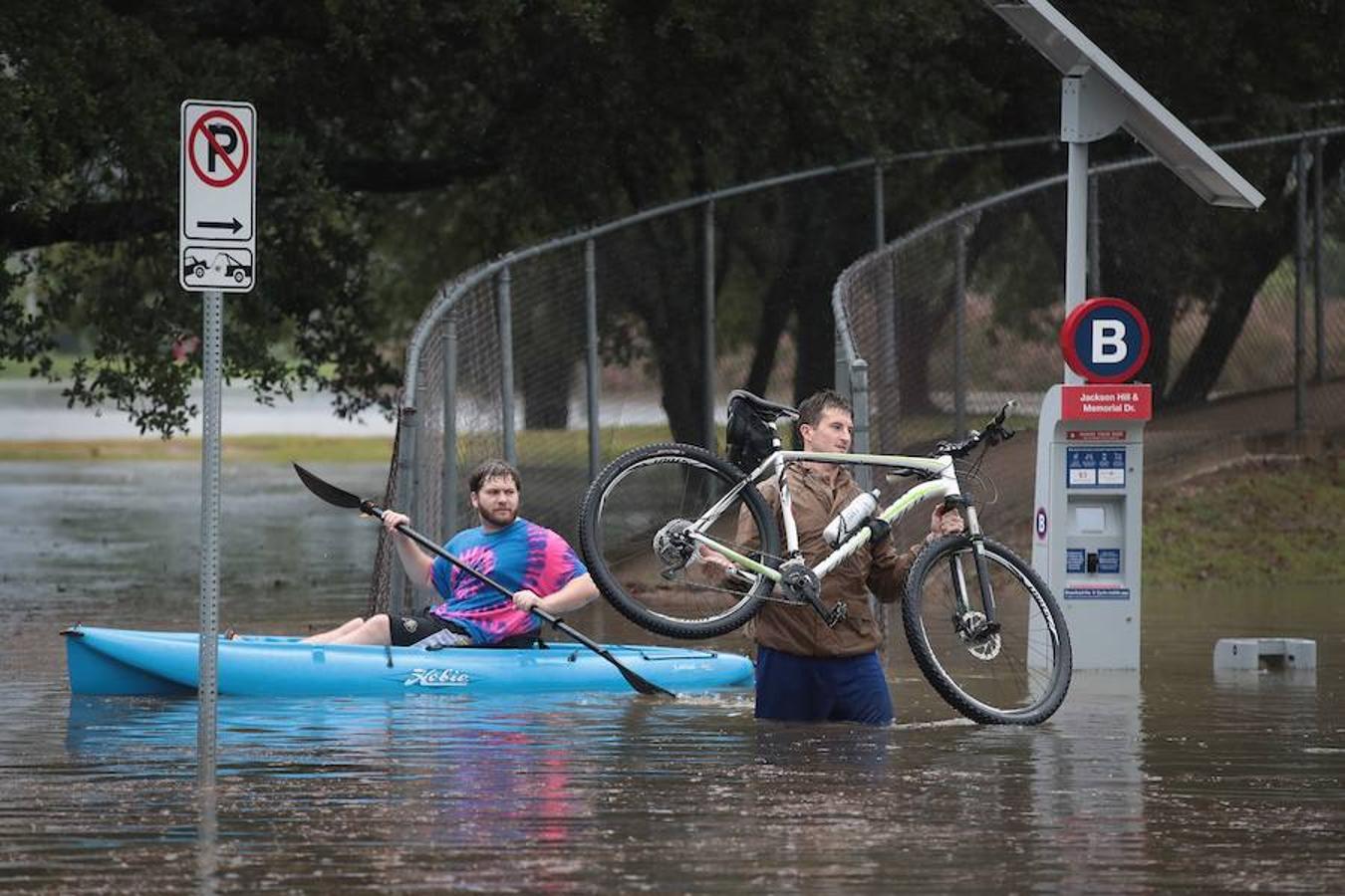 Un hombre navega en una calle inundada.