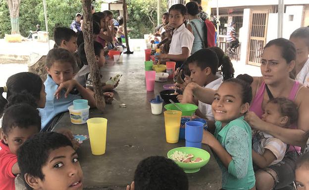 Un grupo de niños come en uno de los centros del programa Alimenta la Solidaridad.