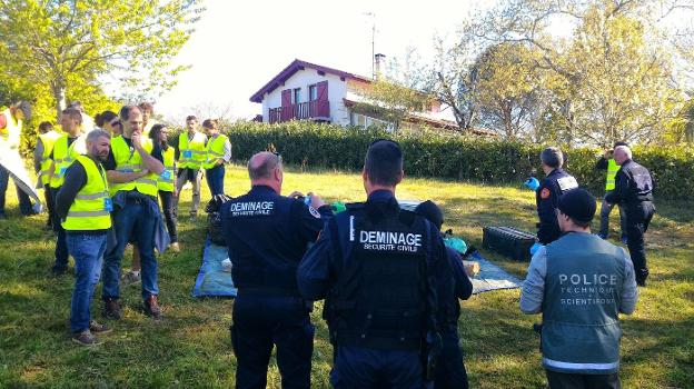 Miembros de la Policía francesa localizan material de ETA en
presencia de un grupo de voluntarios de los Artesanos de la Paz. 