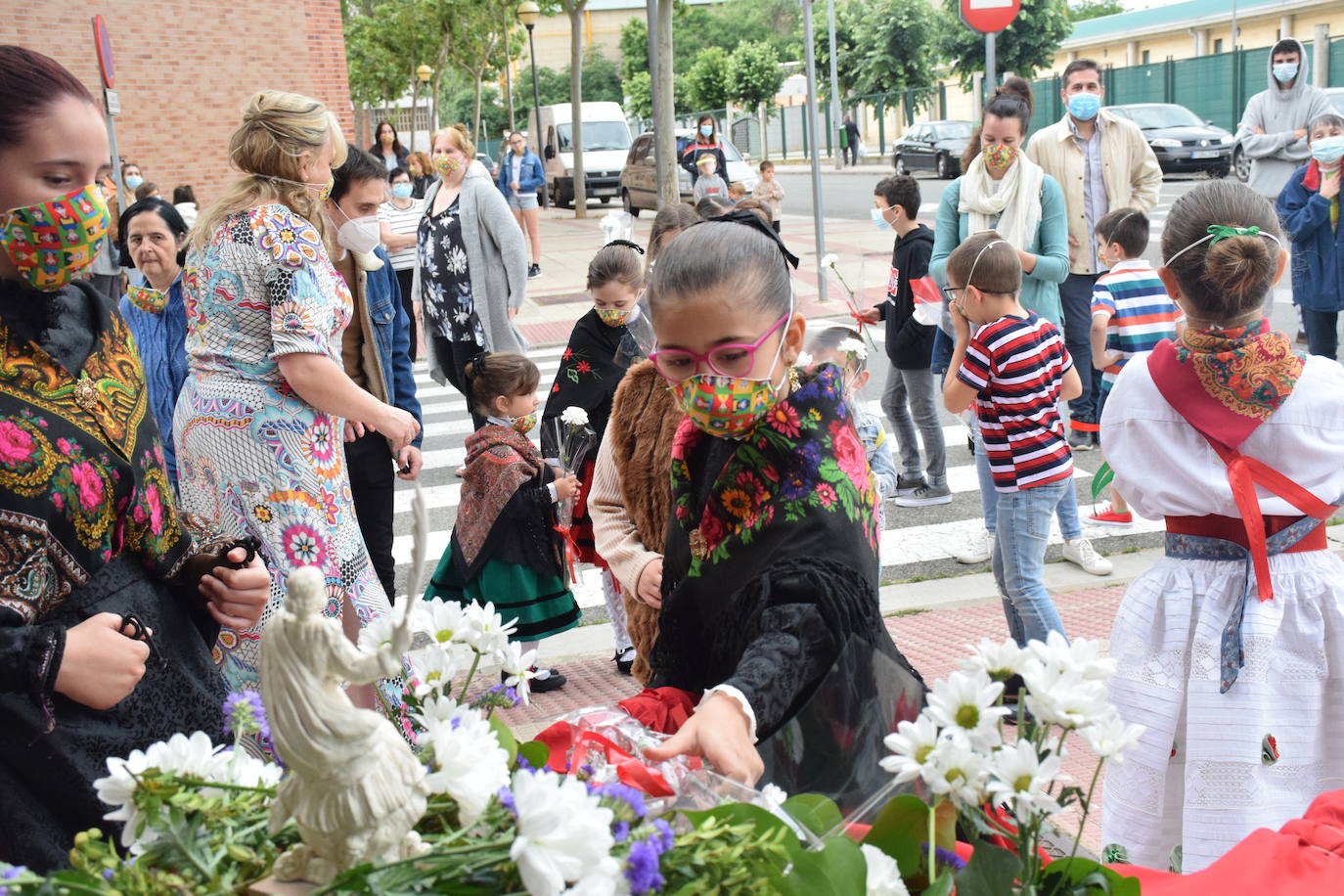 Danzas y flores en la calle por el día del patrón