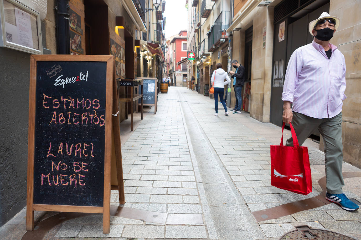 Aún no se escucha el bullicio habitual de un soleado mediodía, pero las calles Laurel y San Juan comienzan a recuperar el pulso. Bares como Achuri, Ángel, Páganos o Bueno... Bueno! ya han subido la verja y la avanzadilla de parroquianos habituales regresa, poco a poco, a sus barras.