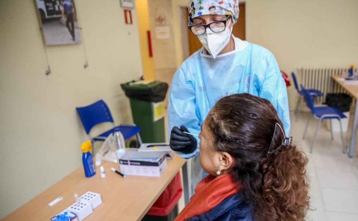 Una sanitaria realiza un test de antígenos a una mujer en un dispositivo organizado por la Comunidad de Madrid 