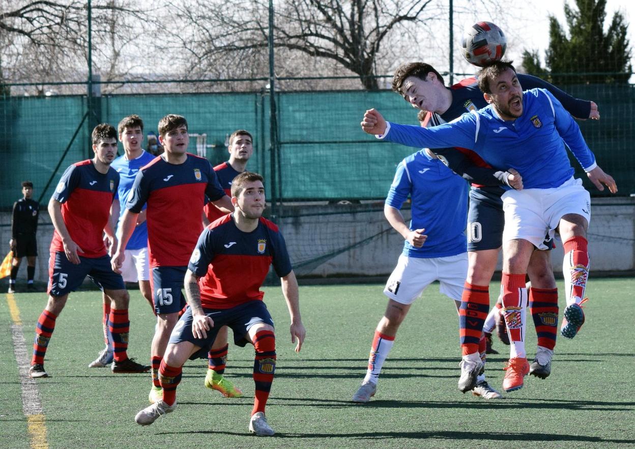 Txori pugna un balón por alto con un rival logroñés. 