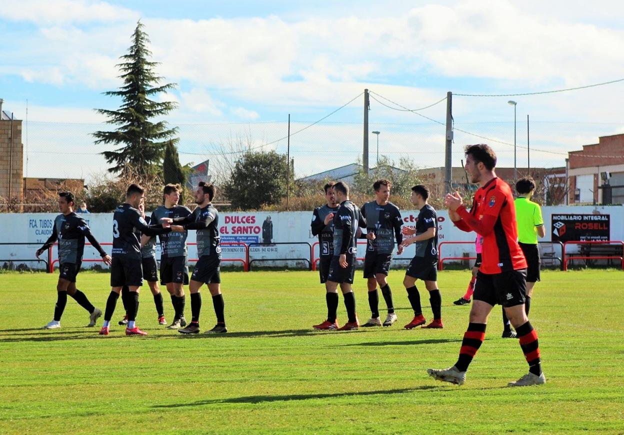 El debutante en La Calzada Martín Gómez anima a sus nuevos compañeros mientras los jugadores del Varea celebran su primer gol en El Rollo. 