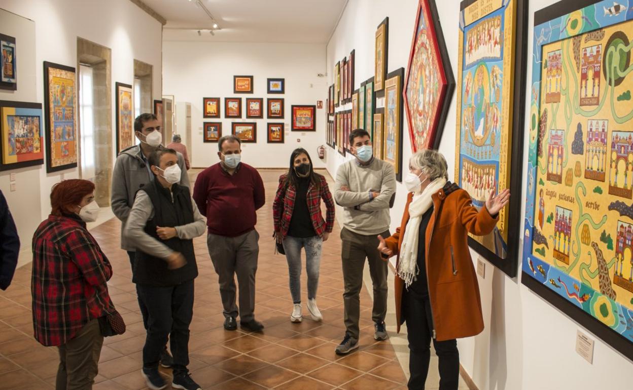 Esther Alonso explica uno de los cuadros durante la inauguración, ayer, de la exposición que se aloja en el convento de San Francisco. 