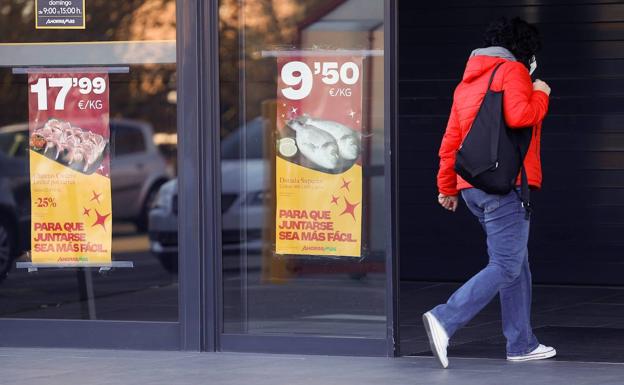 Una mujer camina frente a un supermercado en Madrid. 