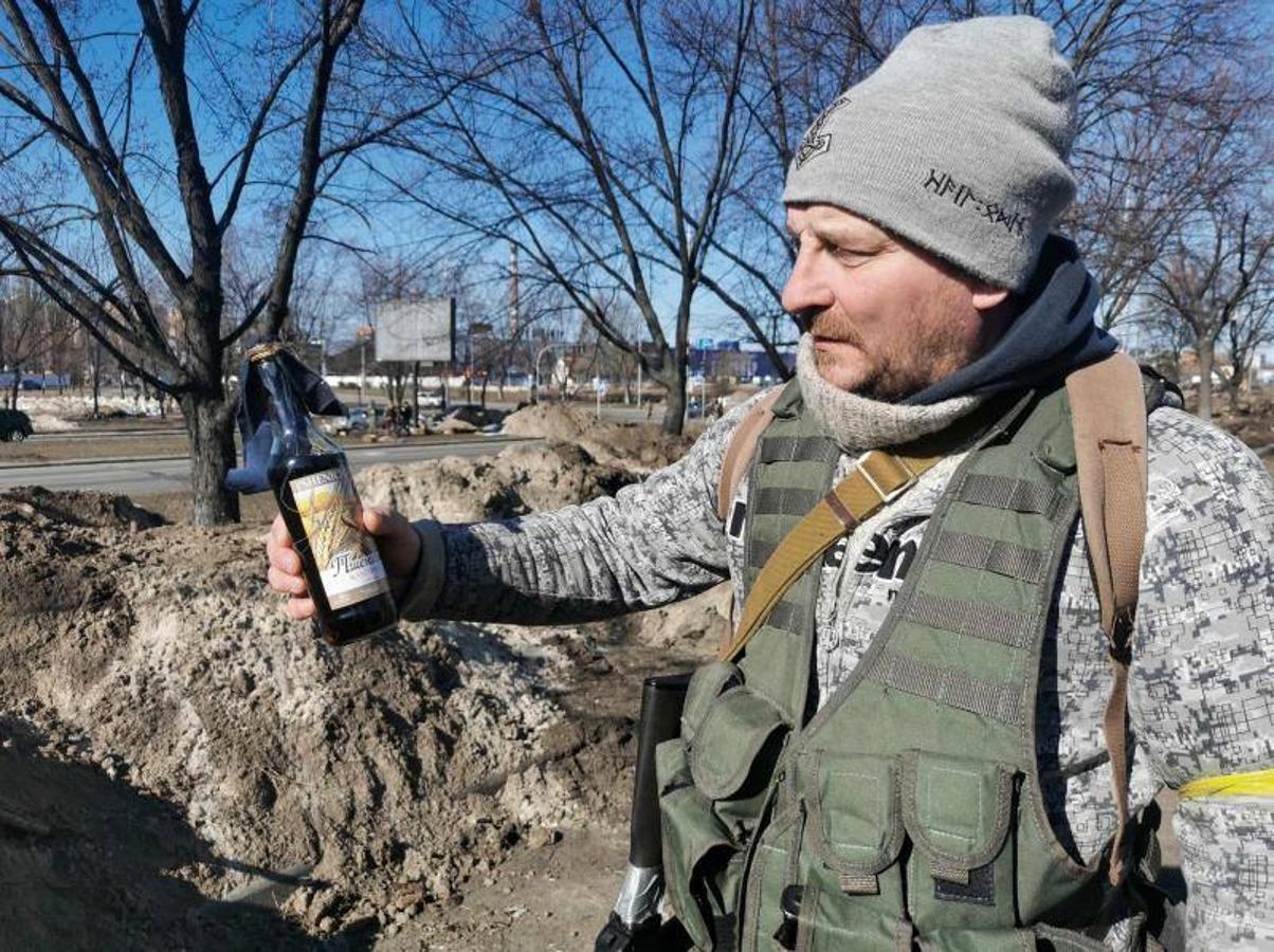 Un voluntario muestra un cóctel molotov que ha preparado.