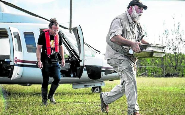 Imagen principal - 1. El chef desciende de un helicóptero con bandejas de comida en el transcurso de una emergencia humanitaria, en una escena del premiado documental 'We feed people'. | 2. Profeta en su tierra. José Andrés, durante la ceremonia del premio princesa de Asturias de la Concordia. | 3. Portada de la revista Time tras ser propuesto al Nobel. 