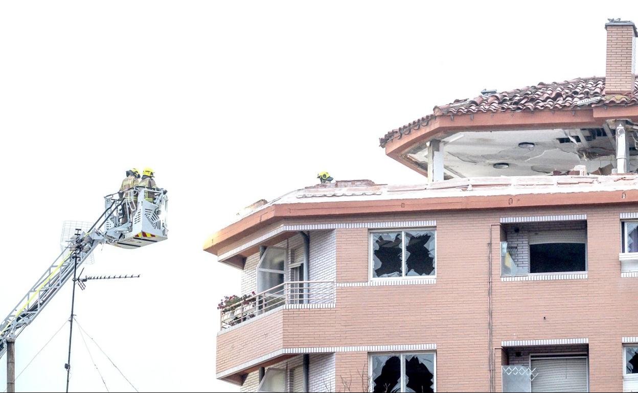 Los bomberos acceden a través de su escalera a las viviendas afectadas el día de la explosión, el 20 de diciembre de 2021. 