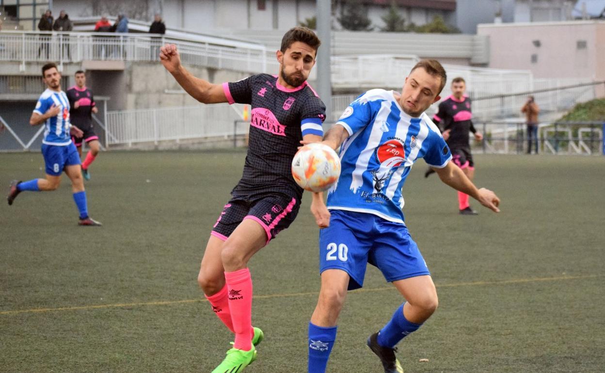 Rojo y Miguel Rodríguez intentan hacerse con el balón. 