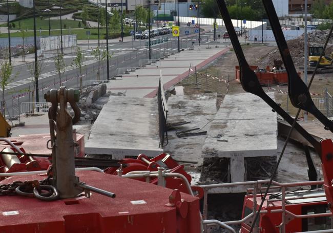 Las piezas desmontadas del puente y las vallas, ya en el suelo junto a la calle