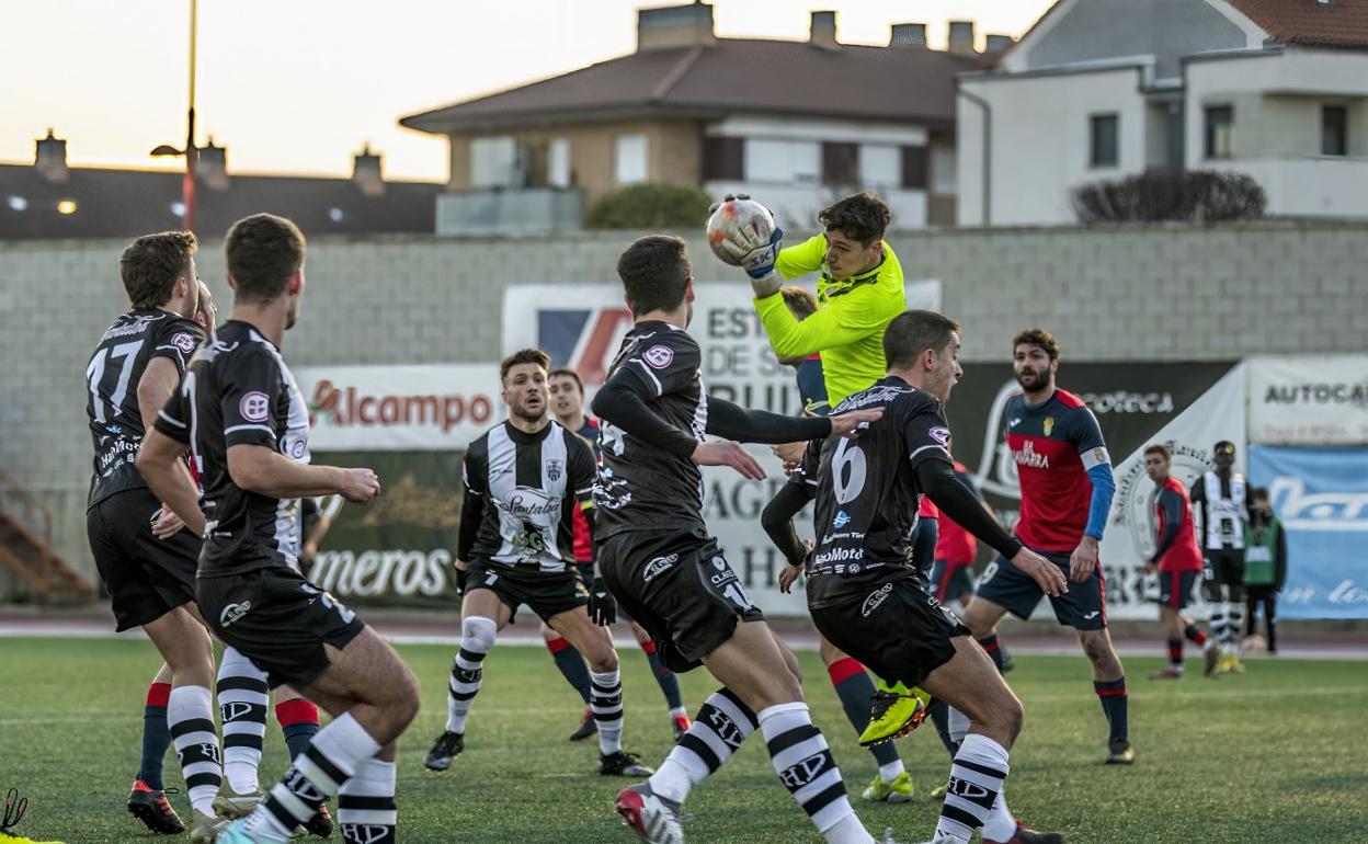 El guardameta navarro Galisteo atrapa el balón ante media plantilla jarrera en un instante del partido. 