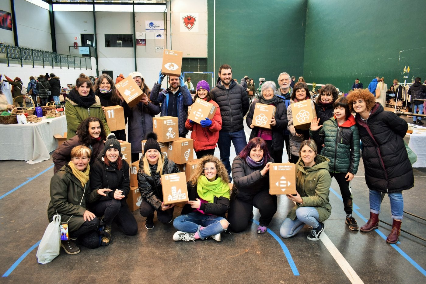 Organizadores y participantes en el mercado 'Huella 0' muestran los objetivos del desarrollo sostenible. 