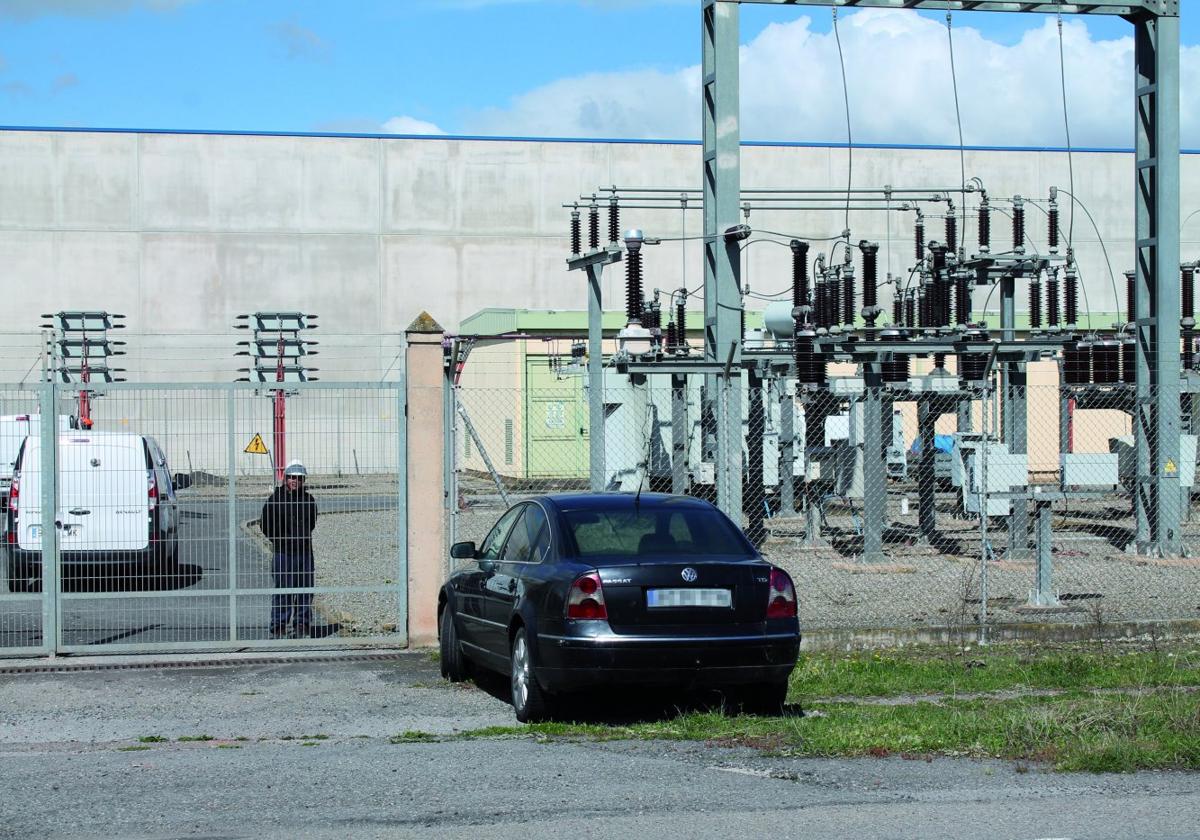 Un trabajador de mantenimiento observa desde la subestación, con el supuesto coche abandonado de los ladrones, en primer plano.