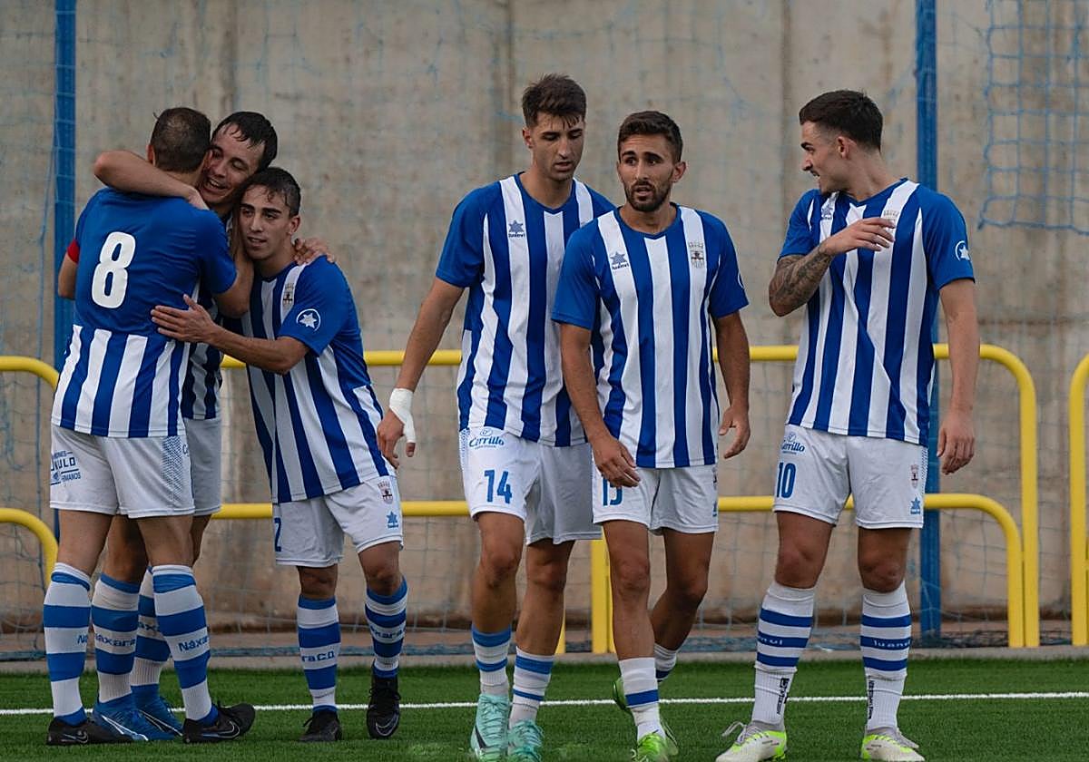 Varios jugadores del Náxara se abrazan con Orodea, el máximo goleador del equipo.