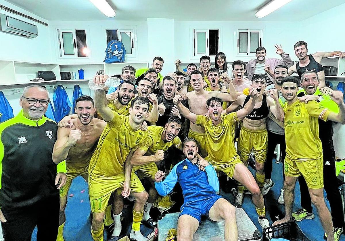 Jugadores y técnicos celebran su triunfo en el vestuario del Municipal de Barbastro.