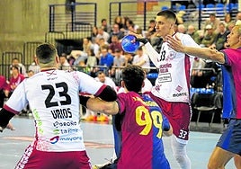 Andrej Pergel pasa un balón mientras Thiagus Petrus intenta impedírselo.