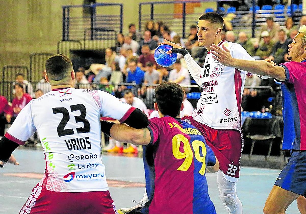 Andrej Pergel pasa un balón mientras Thiagus Petrus intenta impedírselo.