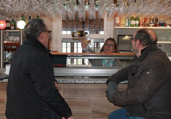 Dos vecinos toman algo en el acogedor bar de la plaza.