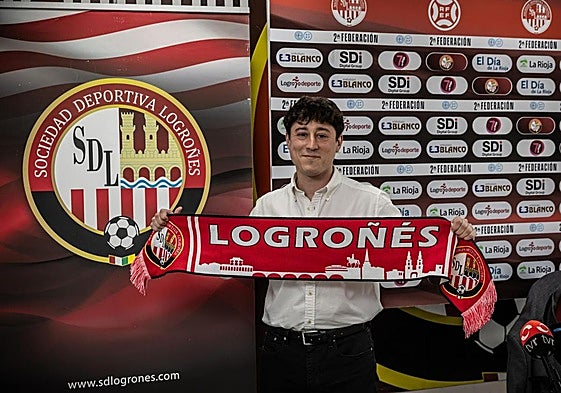 El nuevo director deportivo de la Sociedad Deportiva Logroñés, Iván Martínez, posa con la bufanda del equipo en la sede del club.