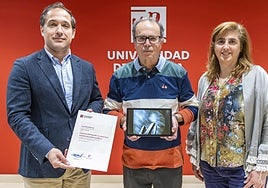 El vicerrector Eduardo Fonseca y la profesora Esther Raya entregan a José Reyes Belzunce el premio del Concurso de Fotografía por la imagen que protagoniza el cartel del congreso.