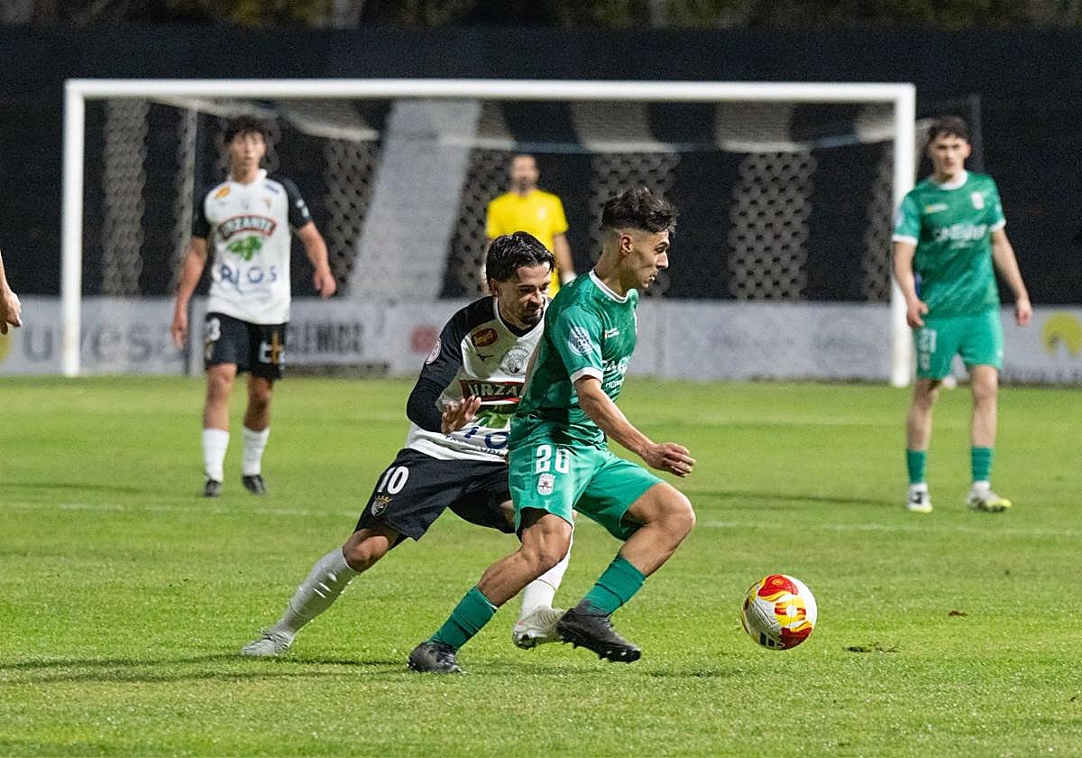 Landín conduce el esférico ante la presión del local Aparicio.