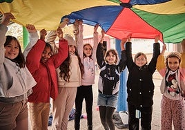 Un grupo de alumnas del colegio Caballero de la Rosa sostienen un colorido 'paracaídas'