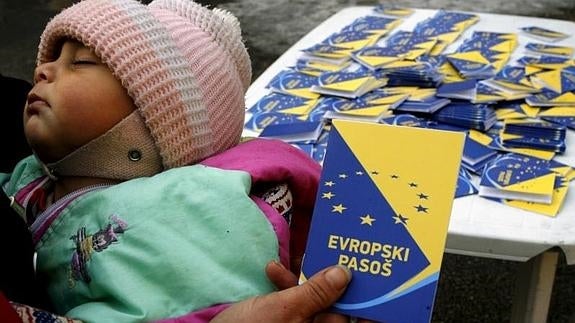 Un voluntario sosteniendo un pasaporte europeo durante una campaña. 