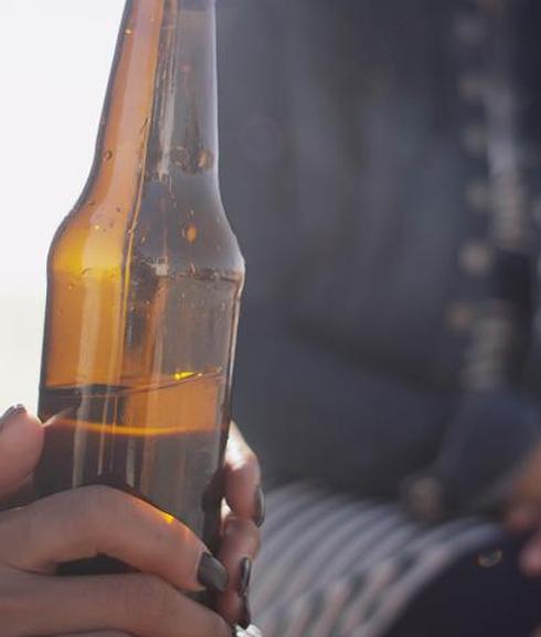 Una joven con una cerveza.