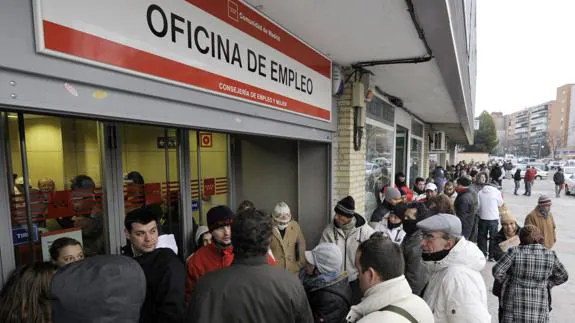 Parados hacen cola ante una oficina de empleo del INEM.