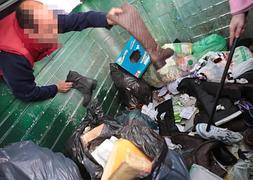 Varias personas buscan pares entre el montón de calzado. ::          S. TERCERO