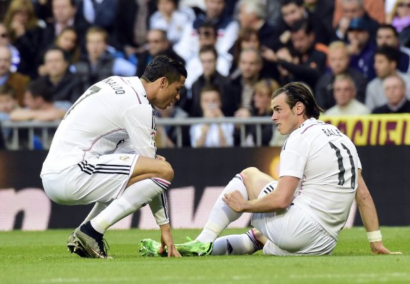 Gareth Bale habla con Cristiano tras lesionarse el sólo izquierdo en los primeros minutos del partido liguero del sábado ante el Málaga. 