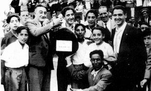 Lacalzada, jefe de personal de la plaza, sostiene el jamón. A la derecha, y en medio de dos niños, Rafael Azcona. ::
L.R.