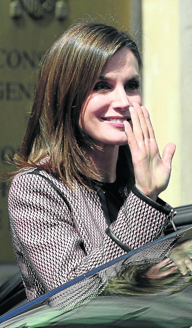 La reina Letizia saluda con una sonrisa al abandonar el centro. 