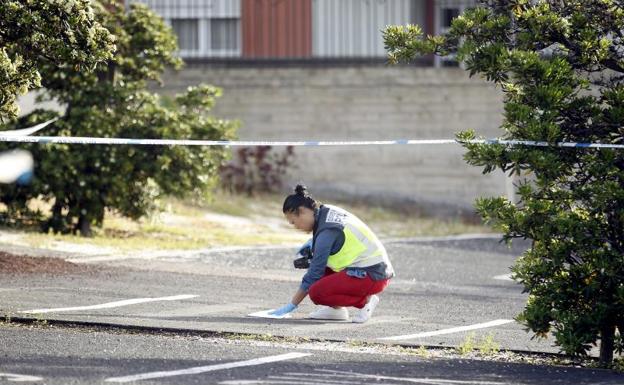 Una policía recoge muestras del lugar de los hechos. 