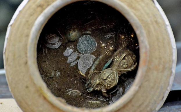 Imagen de una vasija de cerámica con objetos dorados en su interior que forman parte del tesoro descubierto recientemente en la fortaleza de Kaliakra. 