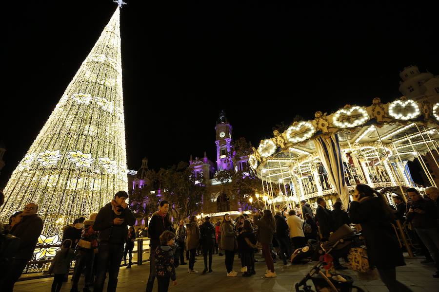 La Plaza del Ayuntamiento de Valencia ha vivido este viernes el encendido oficial de la iluminación navideña. Como gran novedad, este año otros dos barrios y dos pueblos de la ciudad se suman en la apuesta por descentralizar la decoración. Los dos barrios que este año estrenarán árbol de Navidad serán Benicalap y Malilla, sumándose así a las plazas de Patraix, Campanar, Benimaclet, Sant Valer (en Russafa), la Creu del Canyamelar y Doctor Collado (en Ciutat Vella), Orriols, Sant Marcel·lí y Abastos. Serán un total de 11 los árboles que se repartirán por toda la ciudad, además del de la Plaza del Ayuntamiento.