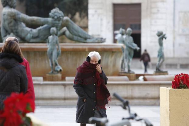 Una mujer pasea abrigada hoy en Valencia. 