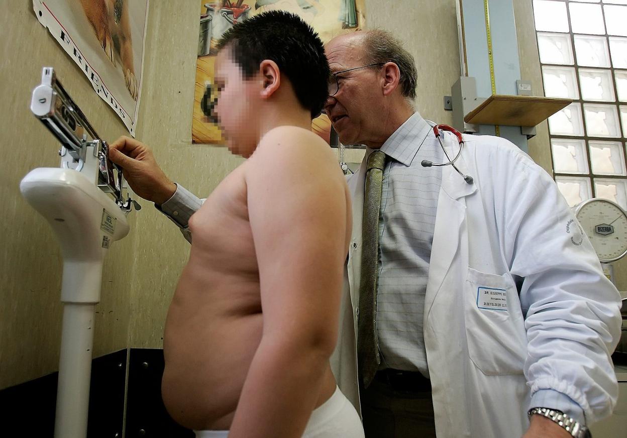 Un niño se pesa en la consulta de un pediatra. 