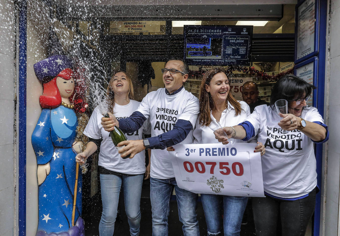 Trabajadores de la administración de la Avenida del Puerto, 173, en Valencia, celebran que han distribuido parte del tercer premio (00750) del Sorteo Extraordinario de la Lotería de Navidad 2019.