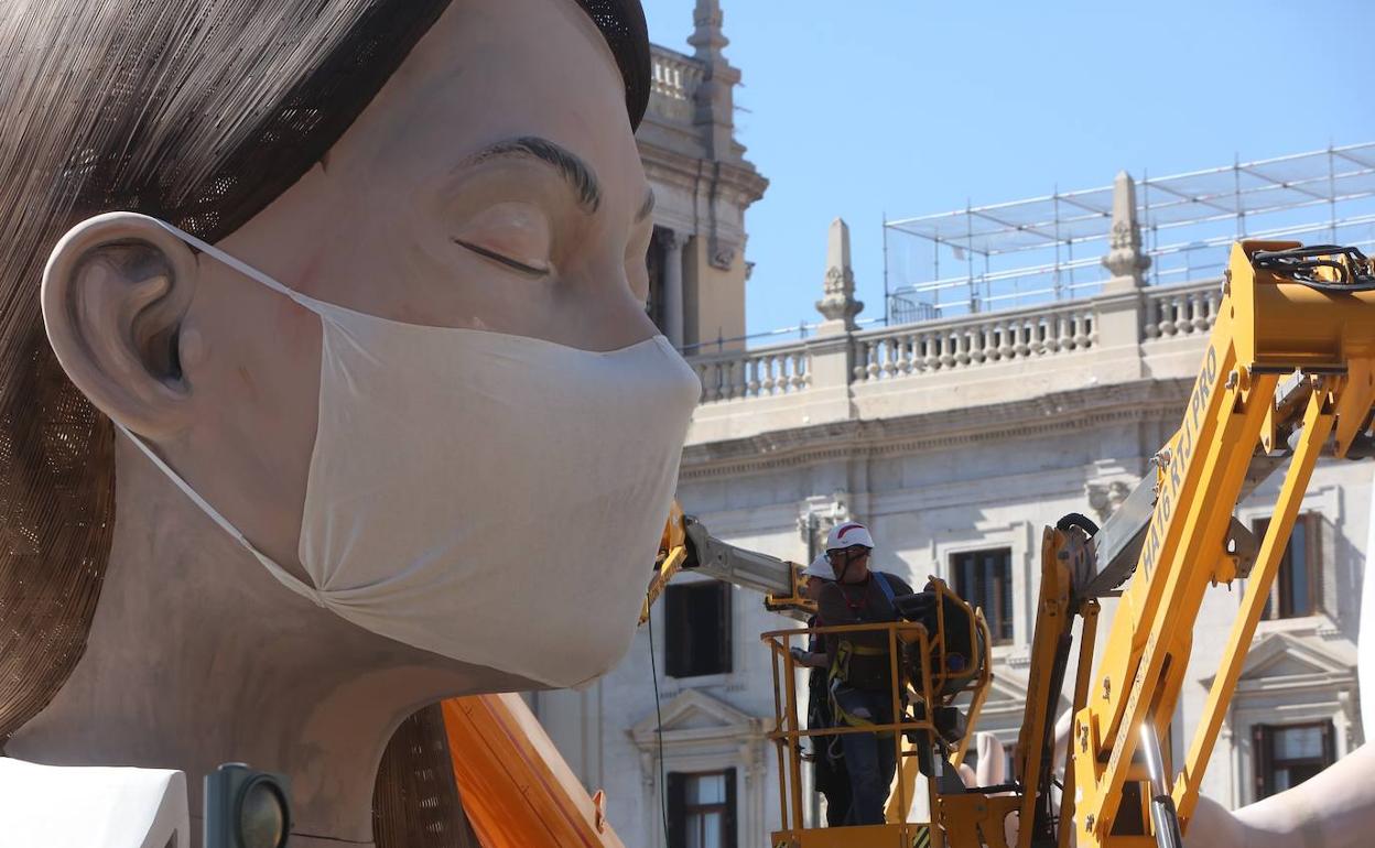 Una mascarilla anticoronavirus cubre la cara de la figura central de la falla municipal. 