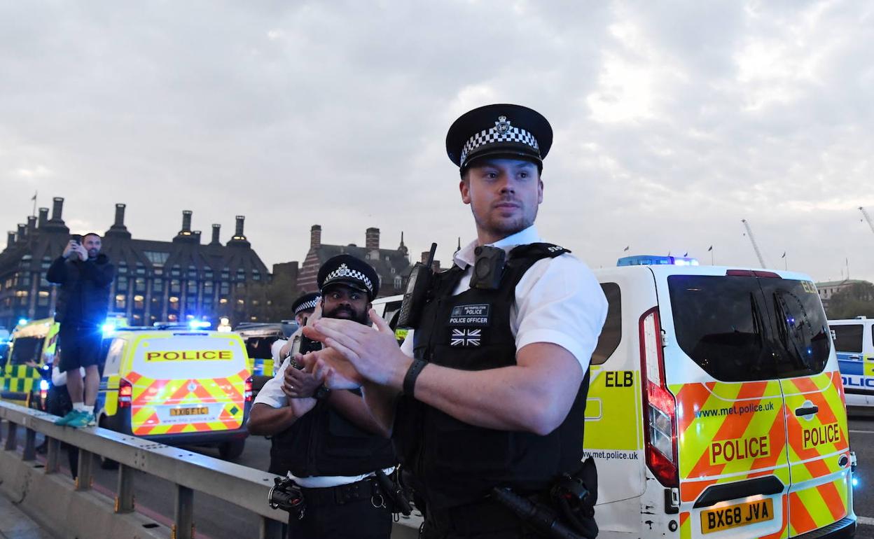 La policía británica aplaude a los sanitarios en el Puente de Westminster en Londres